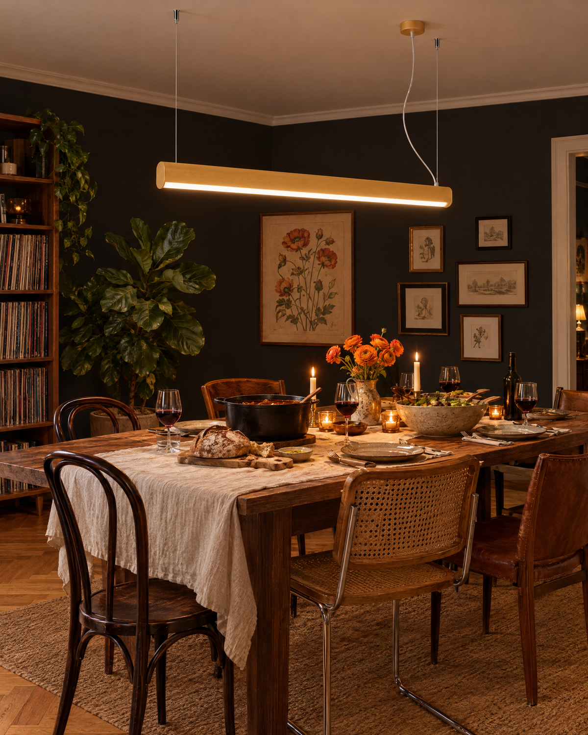 Suspension Farge dorée au-dessus d'une table de dîner dans une salle à manger aux murs noirs